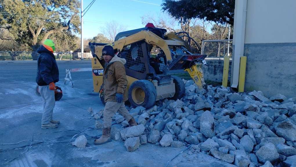 Skid steer breaking out concrete paving